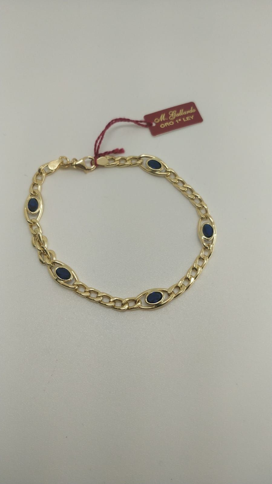 PU458A Pulsera mujer en oro 18k cadena barbada con 5 piedras azules, elegante y sofisticada