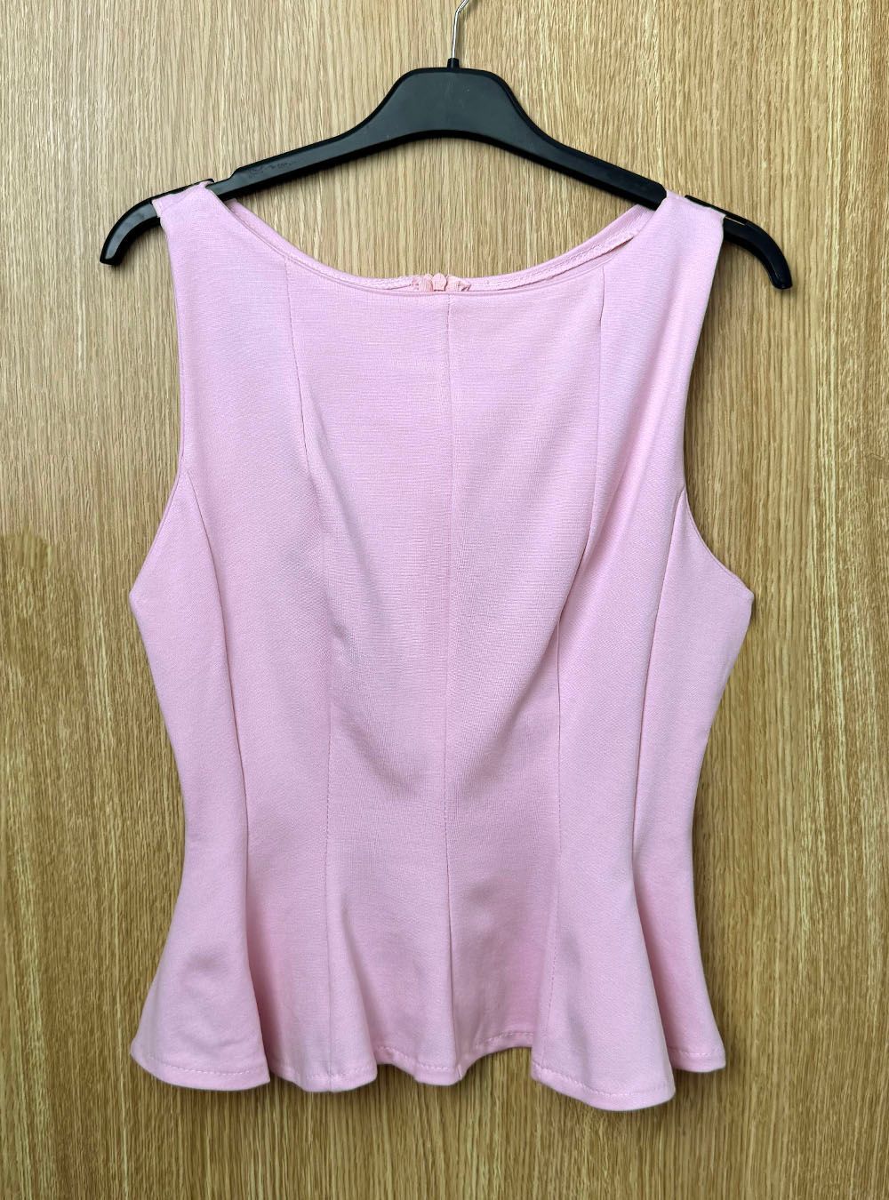 Top sin mangas Peplum rosa